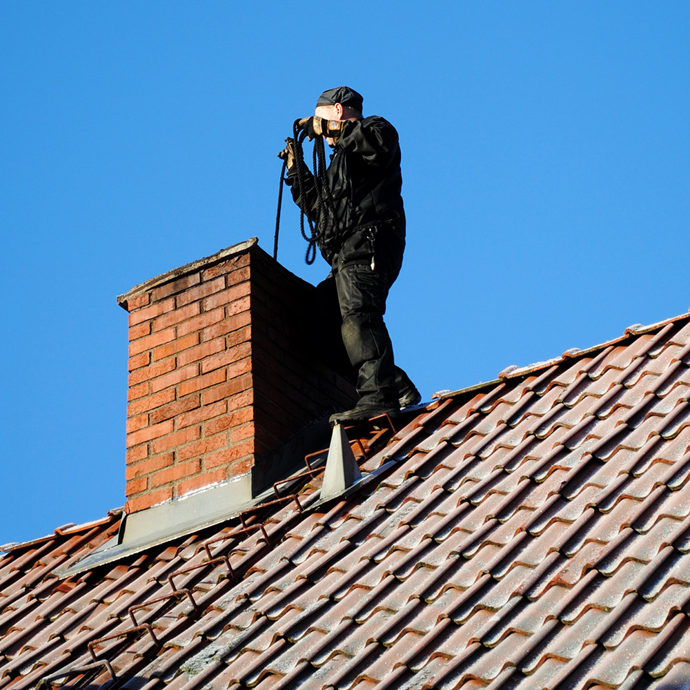Rotary chimney brush moving through a flue