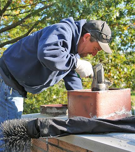 Chimney inspection and cleaning scene at a home